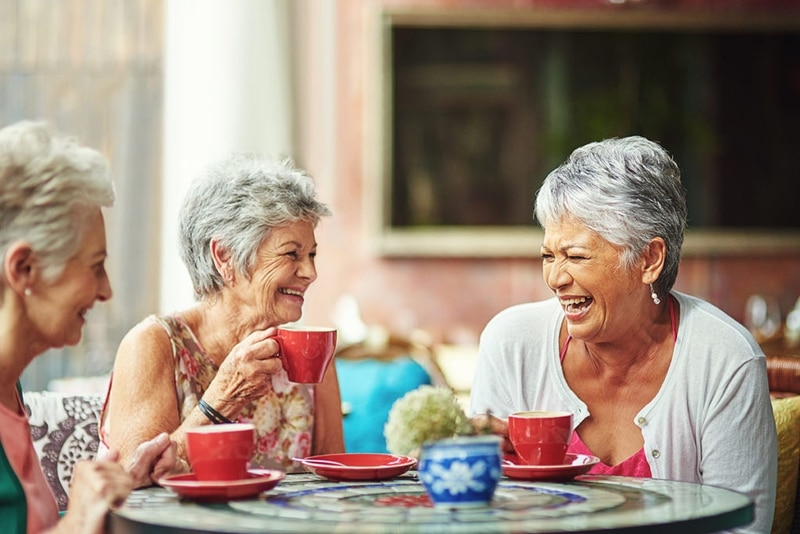 Older Ladies Drinking Coffee and Laughing